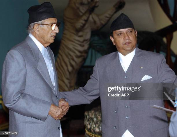 King Gyanendra of Nepal gestures towards newly sworn in Prime Minister Girija Prasad Koirla at a ceremony in Naryanhiti Royal Palace in Kathmandu, 30...