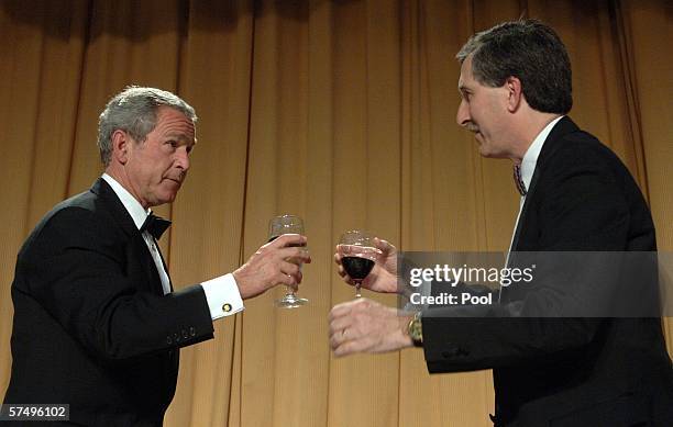 President George W. Bush is toasted by Mark Smith of the White House Correspondents' Association during the White House Correspondents' Dinner April...