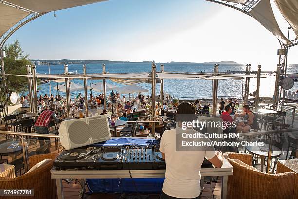 rear view of dj selecting music, cafe del mar, ibiza, spain - café del mar spanien bildbanksfoton och bilder