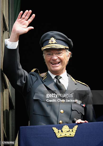 King Carl XVI Gustaf waves from the balcony of the Royal Palace on his 60th Birthday during the changing of the guard at the Stockholm Royal Palace...