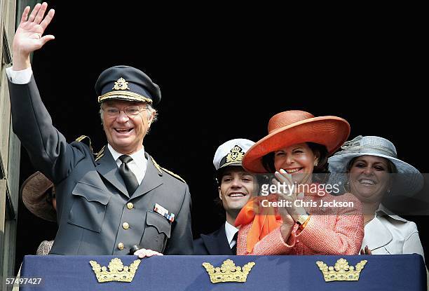 King Carl XVI Gustafs waves from the balcony of the Royal Palace accompanied by Queen Silvia , Prince Carl Philip of Sweden, Princess Madeleine of...