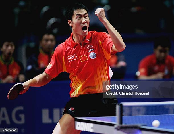 Liqin Wang of China celebrates his 3-2 victory against Timo Boll of Germany in the semifinal during the seventh day of the Liebherr World Team Table...