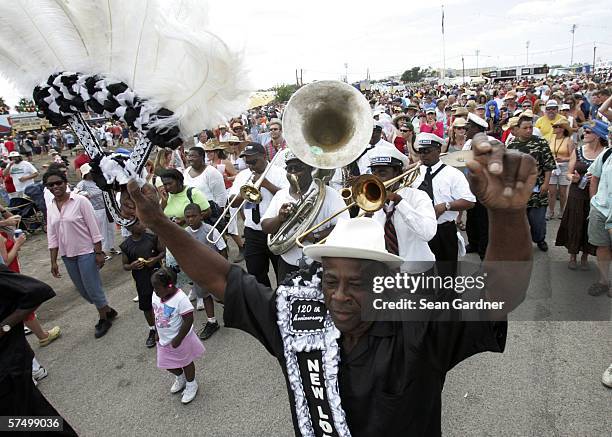 Members of the Young Olympia Aid and New Look Social Aid & Pleasure Clubs, with Paulin Brothers Brass Band, parade through out the crowd during the...