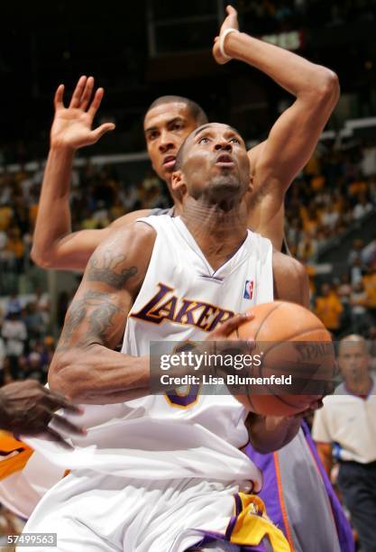 Kobe Bryant of the Los Angeles Lakers drives to the basket past Raja Bell of the Phoenix Suns in overtime of Game Four of the Western Conference...