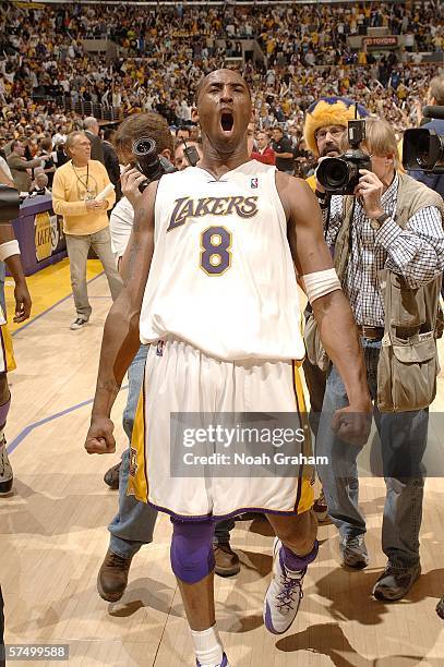 Kobe Bryant of the Los Angeles Lakers celebrates after making the last second game winning shot in overtime against the Phoenix Suns in game four of...