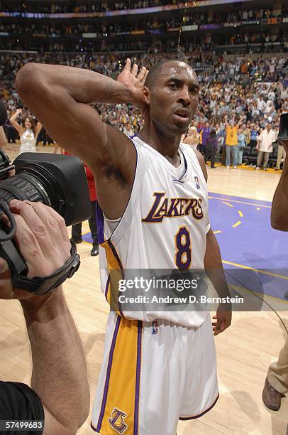 Kobe Bryant of the Los Angeles Lakers celebrates with the crowd after he made the last second game winning shot in overtime against the Phoenix Suns...