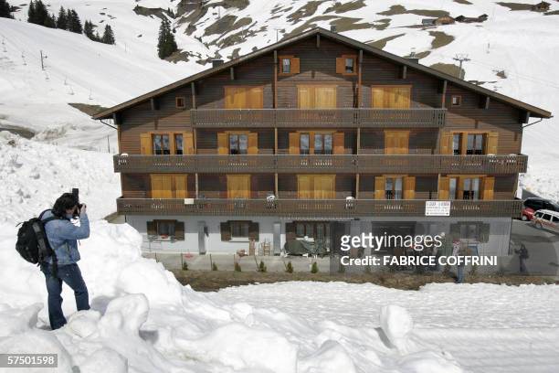 Les Crosets, SWITZERLAND: A journalist photographs 01 May 2006 the chalet home where former Swiss ski champion Corinne Rey-Bellet and her brother...