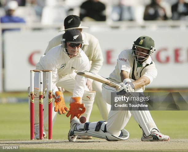 Ashwell Prince of South Africa plays a shot as keeper Brendon McCullum of New Zealand looks on during the fifth day of the second Test match between...