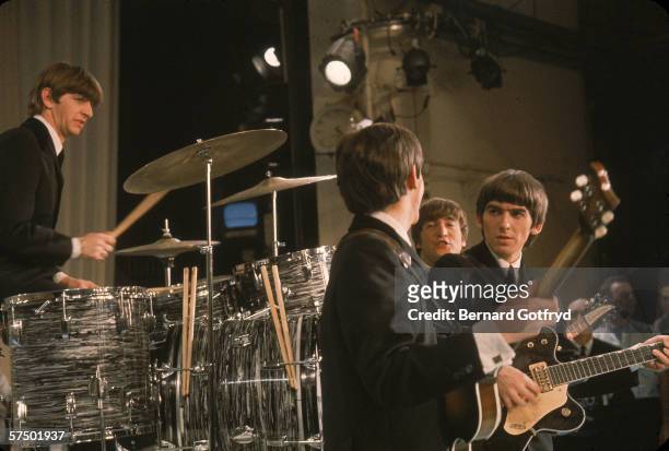 View of the members of British Rock group the Beatles perform onstage during their debut appearance on 'The Ed Sullivan Show' at CBS's Studio 50, New...