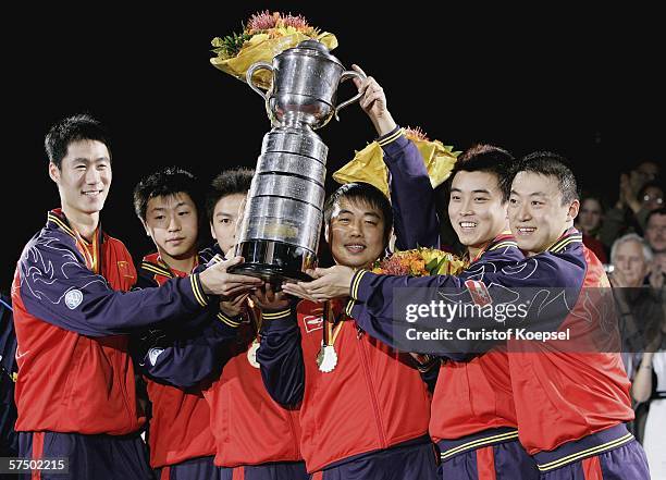 The team of China with Liqin Wang, Long Ma, Qi Chen, head coach Liu Guoliang, Hao Wang, Lin Ma pose with the swaythling cup during the ceremony on...