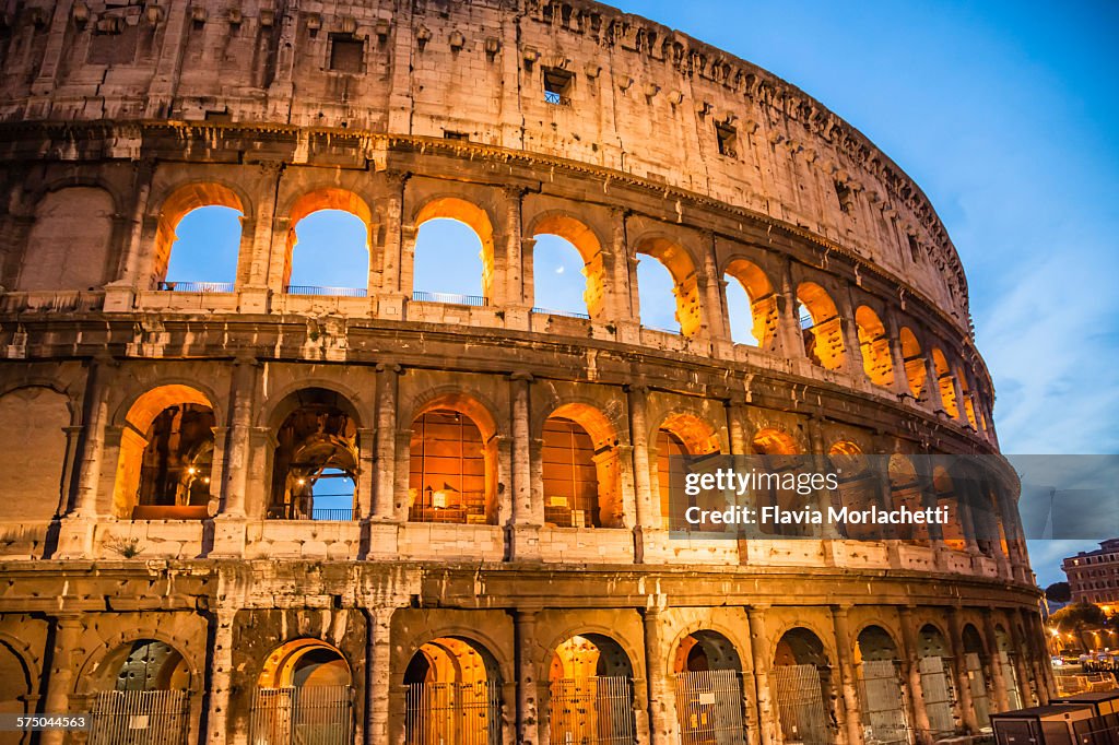 Colosseum in Rome at dusk with moon