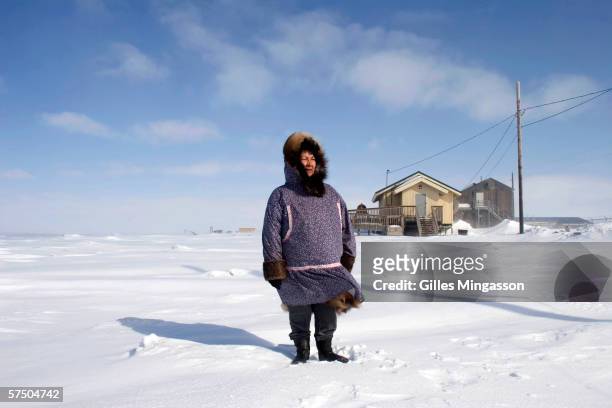 Luci Eningowuk an Inupiat Eskimo and Chaiwoman of Shishnaref's Relocation Commitee, stands on the frozen Chukchi Sea near the shore of Sarichef...