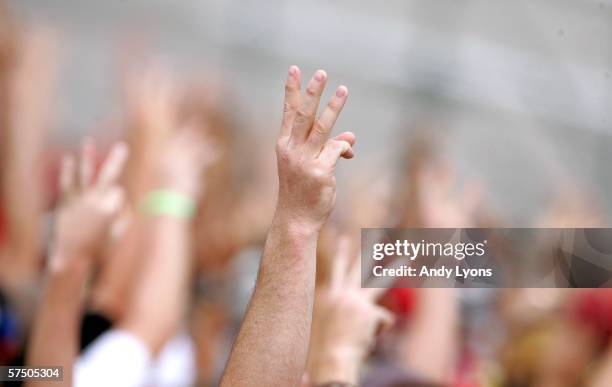 Fans hold up 3 fingers in remembrance of Dale Earnhardt during the NASCAR Nextel Cup Series Aaron's 499 at the Talladega Superspeedway on May 1, 2006...