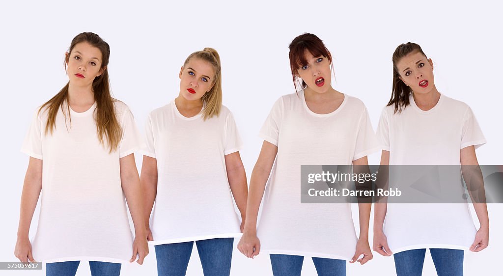 Four girls side by side wearing white t-shirts