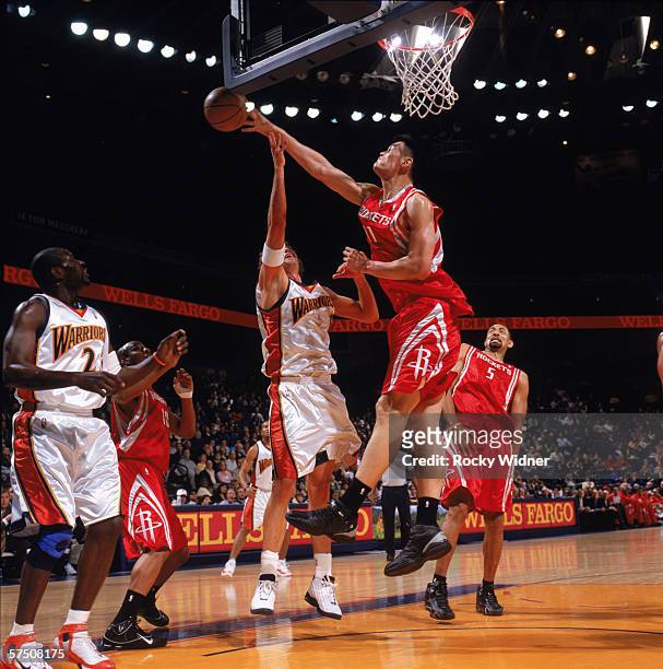 Yao Ming of the Houston Rockets blocks a shot by Troy Murphy of the Golden State Warriors during a game at The Arena in Oakland on April 7, 2006 in...