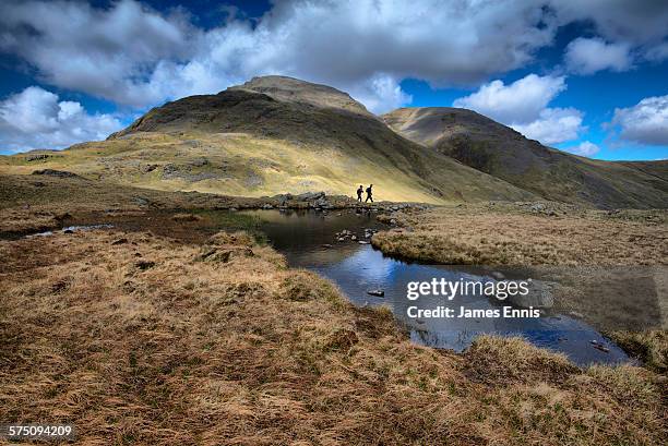 hikers below great gable, english lake district - gable stock pictures, royalty-free photos & images