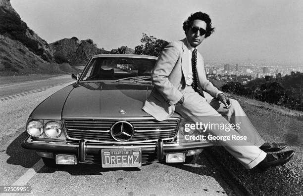 Actor, author, screenwriter and Richard Nixon political speech writer, Ben Stein, poses on the hood of his Mercede Benz during a 1980 Hollywood...