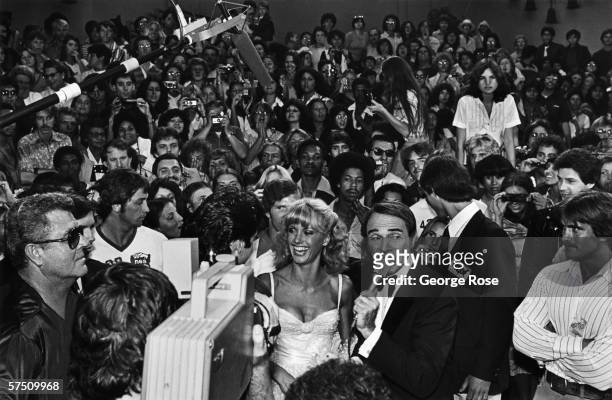 Singer and actress Olivia Newton-John is interviewed by red carpet emcee Army Archerd at the 1978 Hollywood, California film premiere of "Grease"....