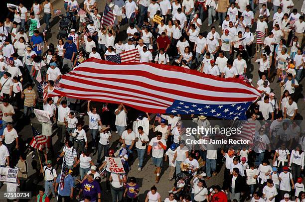 Swarms of people march down Wilshire Boulevard east in support of immigrant rights May 1, 2006 in downtown Los Angeles, California. Immigrants and...