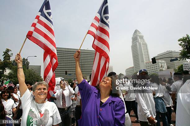 Women carry American peace flags during a rally on what is dubbed a "Day Without Immigrants" or the "Great American Boycott" day on May 1, 2006 in...