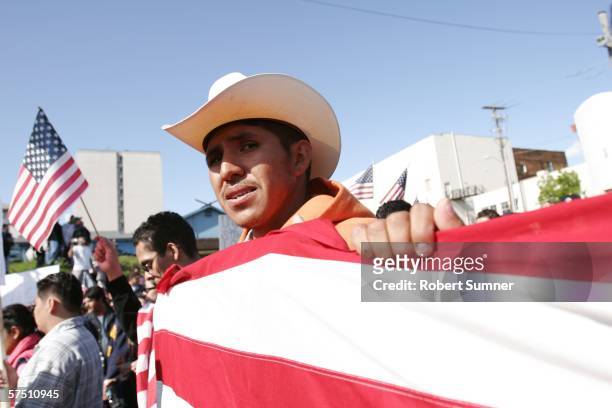 Edgar Juarez marches with an American flag in support of immigrant rights May 1, 2006 in Seattle, Washington. Immigrants and their supporters around...