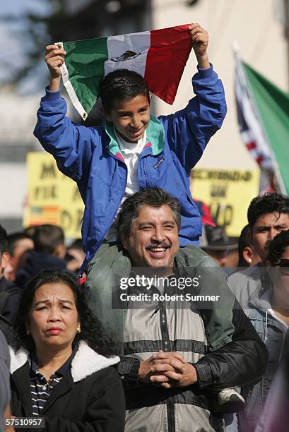 Daniel Pina and his son Yael of Seattle, march toward downtown in support of immigrant rights May 1, 2006 in Seattle, Washington. Immigrants and...