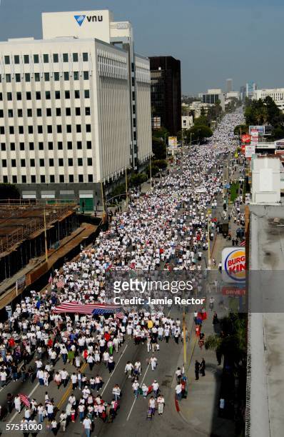 Swarms of people march down Wilshire Boulevard east in support of immigrant rights May 1, 2006 in downtown Los Angeles, California. Immigrants and...