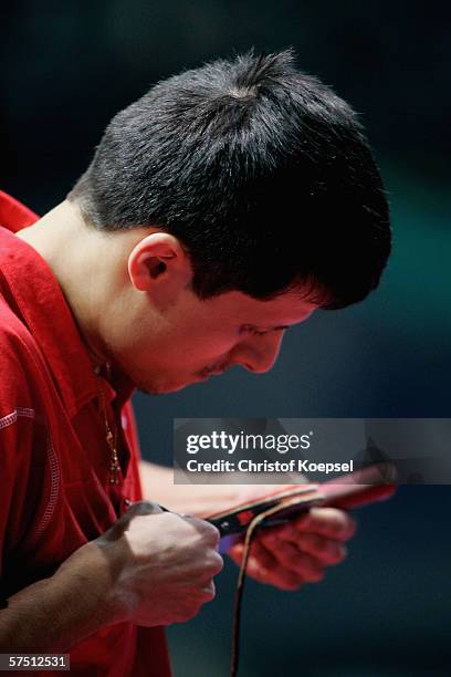 Alexei Smirnov of Russia prepares his paddle before the match against Christian Suss of Germany in the quarter-final during the sixth day of the...