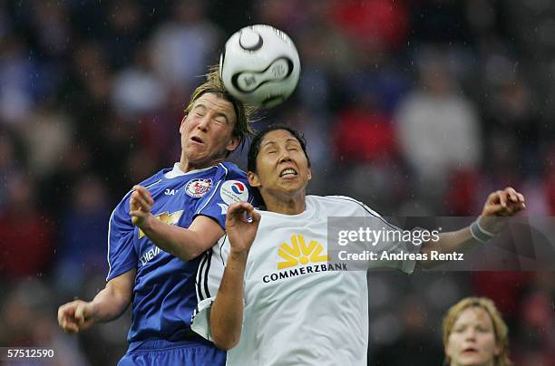 Inken Becher of Potsdam and Steffi Jones of Frankfurt battle for a header during the Women's DFB German Cup final between 1.FFC Turbine Potsdam and...