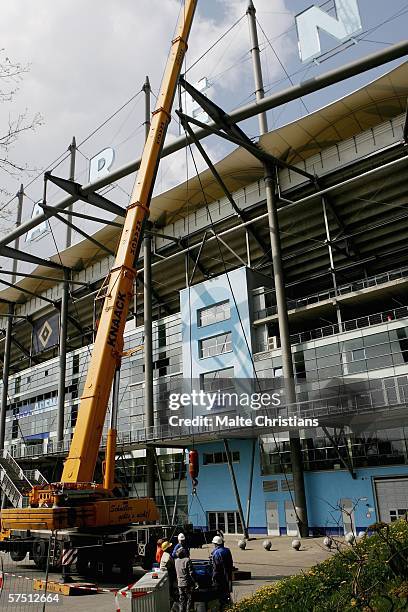 Crane lifts up worker to the letter "N" of the AOL Arena, carrying away the name of the sponsor on May 2, 2006 in Hamburg,. The name of the stadium...