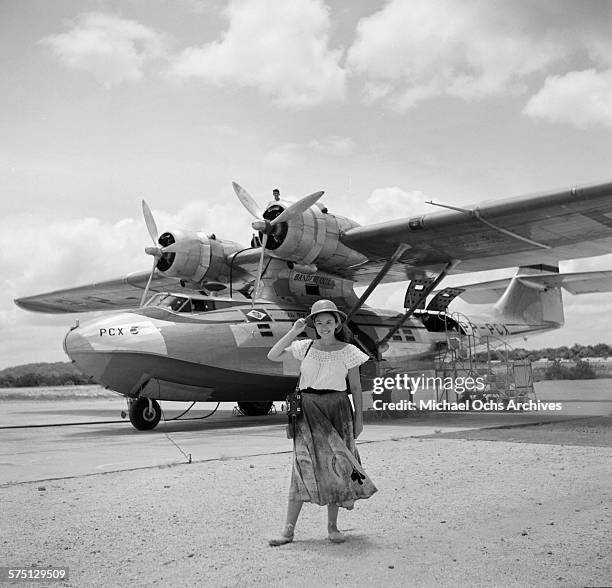 Women poses by a Convair Catalina float plane at Val de Cans International Airport in Belem,Brazil.