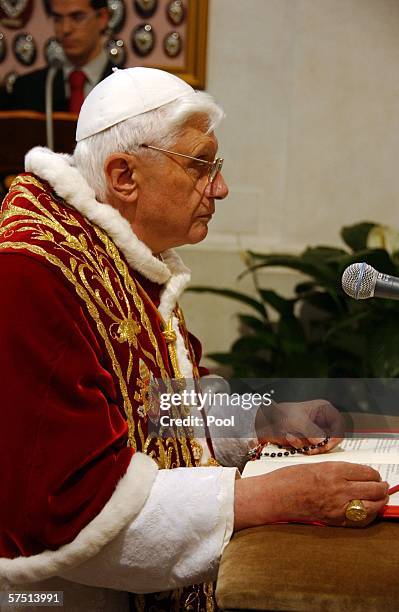 Pope Benedict XVI kneels in prayer while holding a rosary during a visit to the Sanctuary of Madonna del Divino Amore which is located approximately...