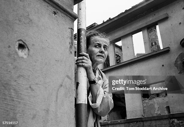 Woman tries to summon up the courage to run across 'Sniper Alley' during fighting in Sarajevo in 1994.