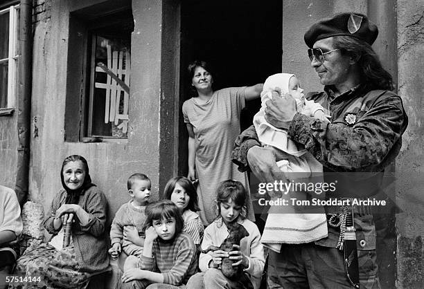 Before leaving to join his comrades on the frontline Bosnian fighter Hamzic Sejad kisses his 6 week old daughter, Vanessa, goodbye in 1993.