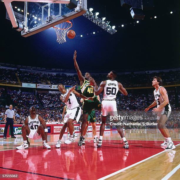 Shawn Kemp of the Seattle Supersonics shoots against David Robinson and J.R. Reid of the San Antonio Spurs during the 1994 NBA Challenge at the...
