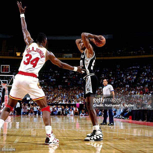 David Robinson of the San Antonio Spurs looks to pass against Hakeem Olajuwon of the Houston Rockets during the 1994 NBA Challenge at the Palacio de...