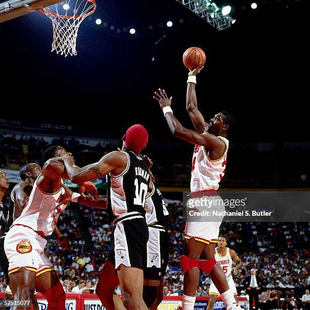 Hakeem Olajuwon of the Houston Rockets shoots against David Robinson and Dennis Rodman of the San Antonio Spurs during the 1994 NBA Challenge at the...