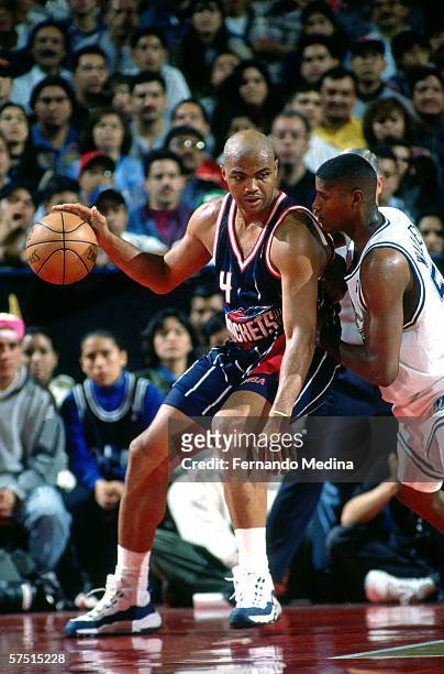 Charles Barkley of the Houston Rockets backs down Samaki Walker of the Dallas Mavericks on December 6, 1997 at the Palacio de los Deportes in Mexico...