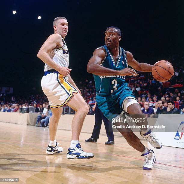 Hersey Hawkins of the Charlotte Hornets drives to the basket against Chris Mulliin of the Golden State Warriors during the 1994 Europe Tour at the...