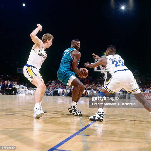 Larry Johnson of the Charlotte Hornets attempts to dribble against Ricky Pierce of the Golden State Warriors during the 1994 Europe Tour at the...