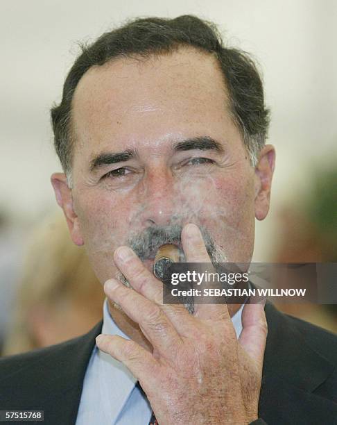 Picture taken 06 September 2003 in Wolfsburg shows the CEO of German car maker Volkswagen Bernd Pischetsrieder smoking a cigar. The company's...