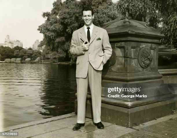 elegant man with pipe by park lake, (b&w), portrait - smoking pipe stock pictures, royalty-free photos & images