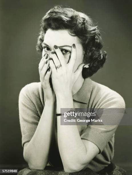 woman covering face, peeping through fingers, (b&w) - unfashionable woman stock pictures, royalty-free photos & images