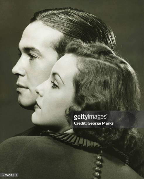 profiles of couple posing in studio, (b&w), close-up, portrait - 1940s woman stock pictures, royalty-free photos & images