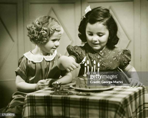 two girls (3-4), (4-5) sitting at small table with birthday cake, (b&w) - kid birthday cake stock pictures, royalty-free photos & images