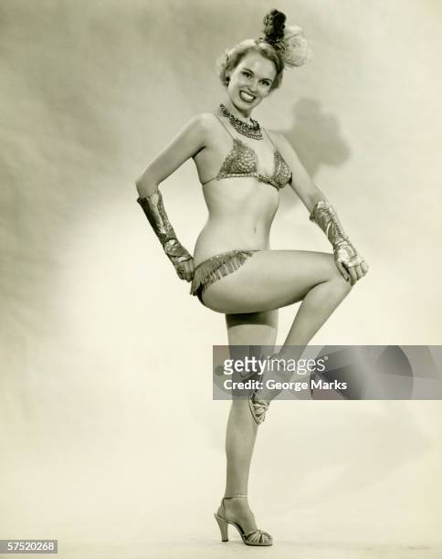 young woman standing in show girl costume, (b&w) - showgirl stockfoto's en -beelden