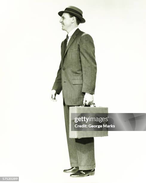 businessman standing in studio, holding briefcase, (b&w) - old briefcase stock pictures, royalty-free photos & images