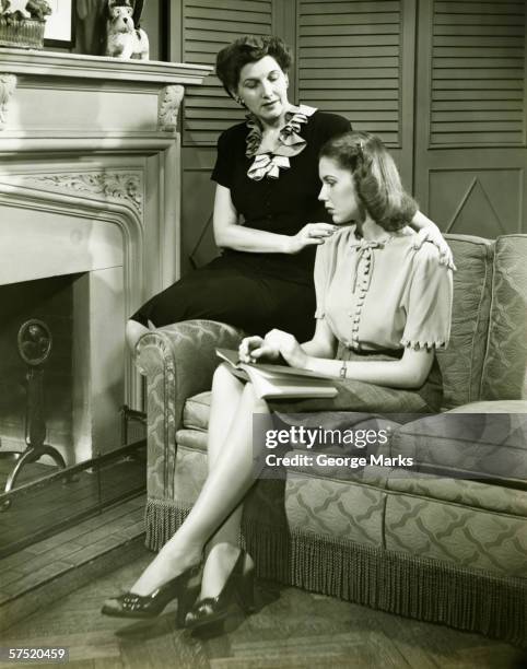 two women sitting on couch, discussing, (b&w) - sitting indoor stock pictures, royalty-free photos & images