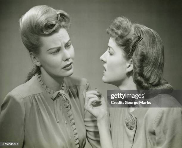 two young women having serious discussion, (b&w) - beehive hair stock pictures, royalty-free photos & images