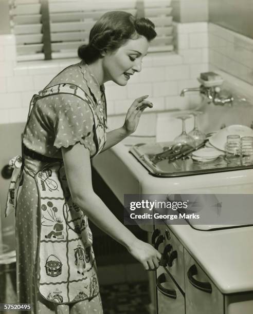 young woman working in kitchen, (b&w), portrait - housewife stock pictures, royalty-free photos & images